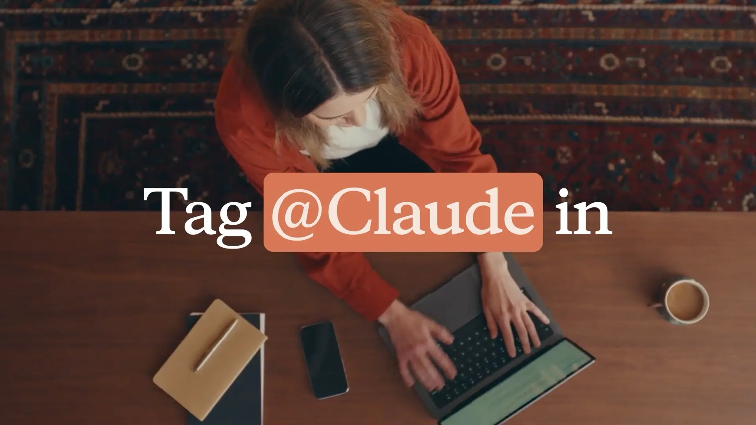 Anthropic's Claude Tag announcement: a person working at a laptop, captioned Tag @Claude in
